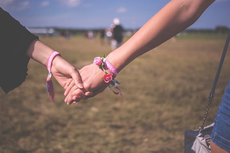 Stock photo of friends holding hands