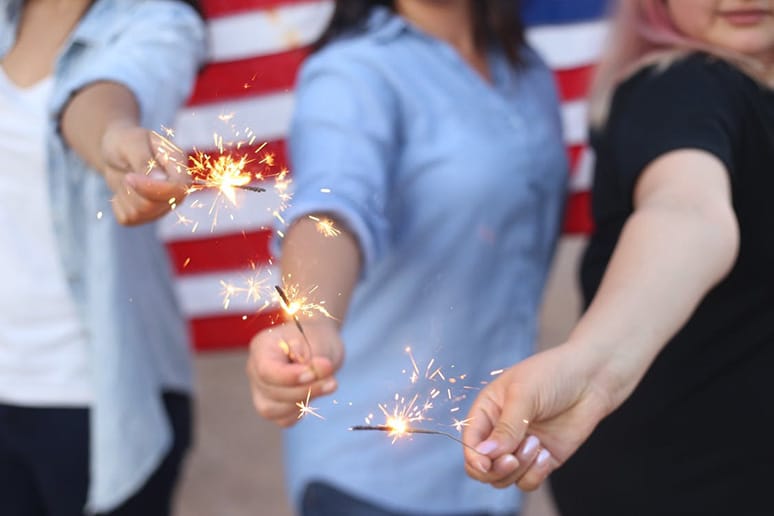 women holding sparklers on 4th of July